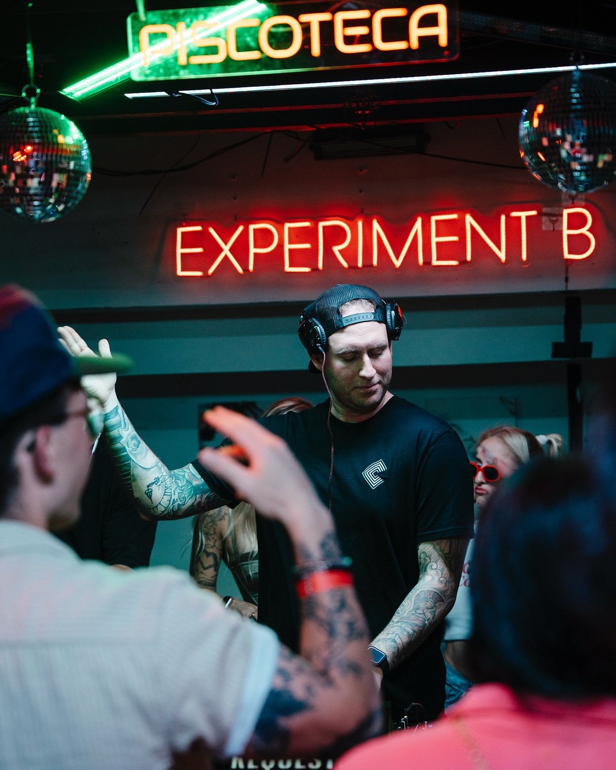 Chemikkal in the booth at Discoteca Experiment B, surrounded by crowd and disco balls